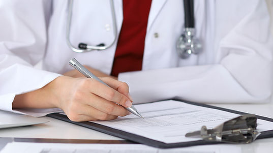 Doctor writing on paper.
