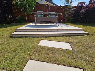 CMA Construct lawn and cream tiles making a path and small raised patio
