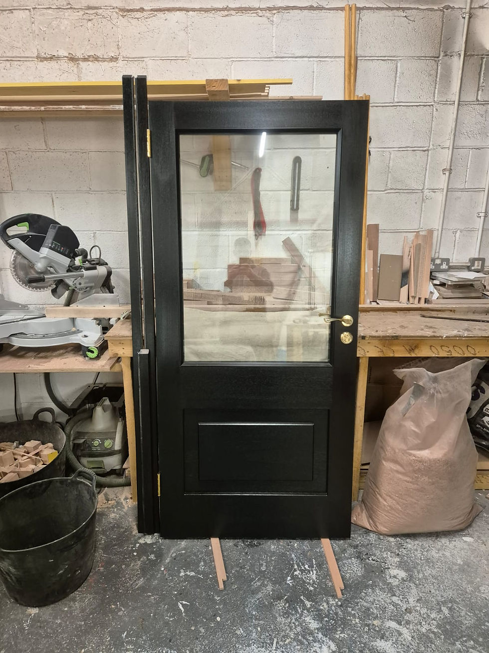 Wooden front door with glass panel in a workshop