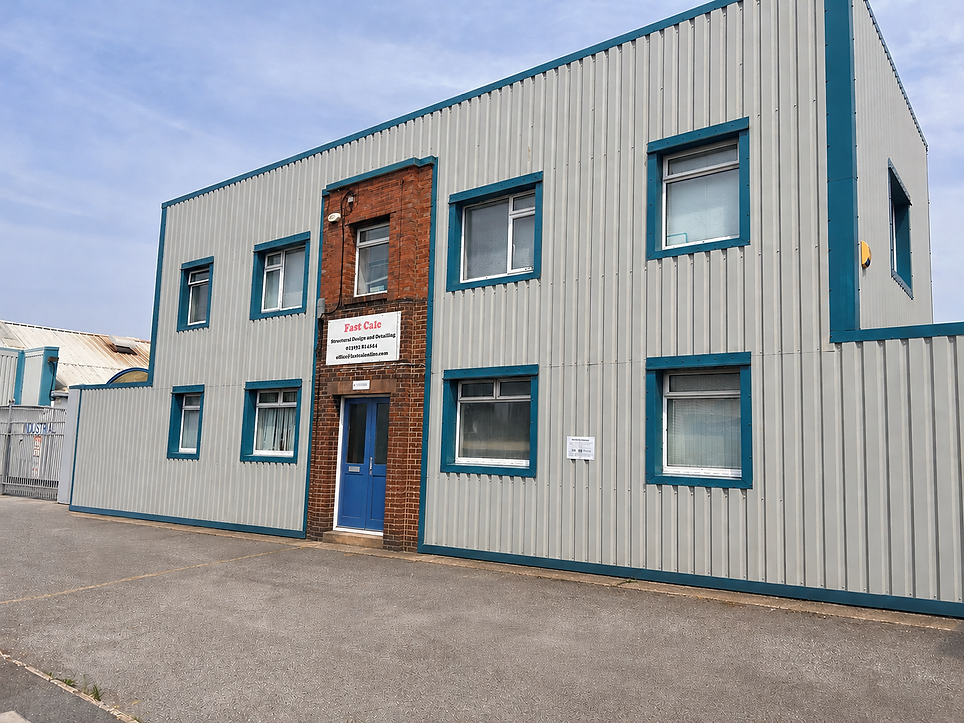 Exterior view of a two-storey industrial building with corrugated metal cladding