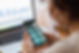 Woman viewing her smart home app and computer