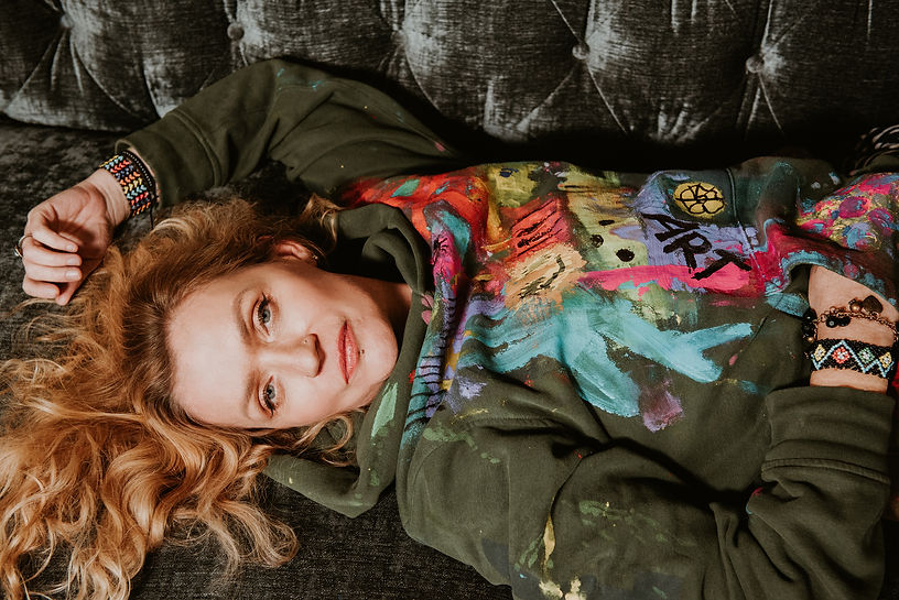 Portrait of Adriana laying down and staring up at the viewer