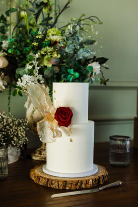 Simple white chocolate ganache wedding cake with fresh florals and rice paper sails. East Riding of Yorkshire