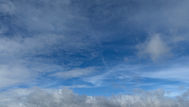 A blue sky of a mutlitude of blues with clouds
