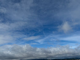 A blue sky of a mutlitude of blues with clouds