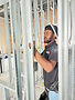 K Engineering electrician running wiring during a commercial build-out