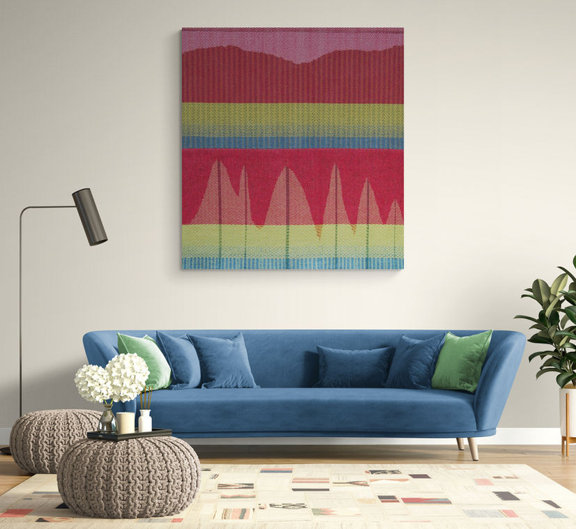 Tapestry style wool hanging in room with blue sofa