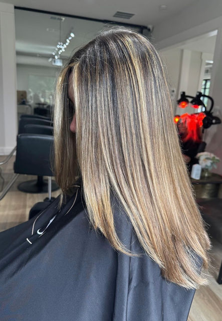 Blonde balayage with soft highlights creating a sun-kissed, natural look at The Standard Salon in Suwanee, GA.