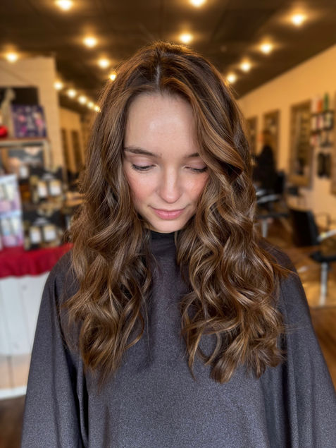 Dimensional brunette hair with subtle highlights and lowlights for a soft, natural look in Dacula, GA.