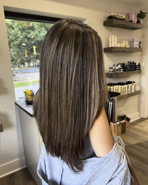 Dimensional brunette hair with subtle highlights and lowlights for a soft, natural look in Suwanee, GA.