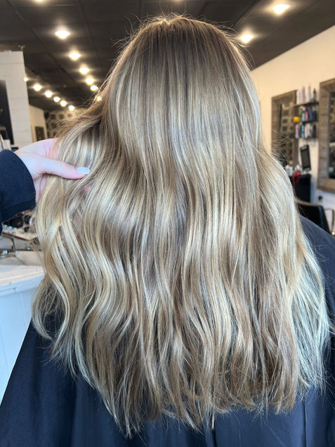Sun-kissed blonde hair with natural highlights for a fresh, glowing look in Dacula, GA.