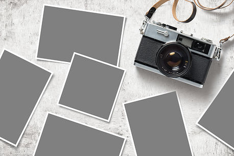photo mockup or template with vintage analog camera and paper prints images scattered on a