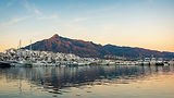 Puerto Banús marina in Marbella at sunset with La Concha mountain