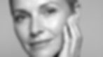 Woman with smooth skin touching her cheek