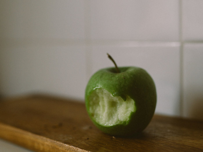 Green apple with a bite taken out