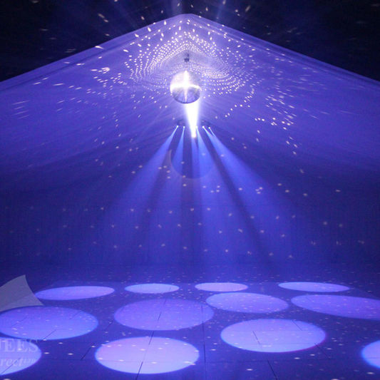 Marquee with silver mirror ball and purple pin spots on dance floor 