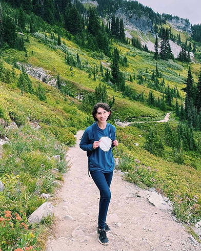 A Washington elopement photographer smiles on a trail in Mount Rainier National Park