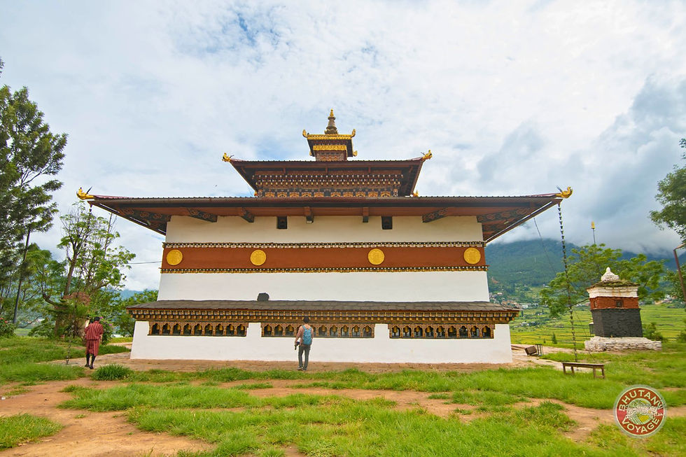 Traveler walking near Gangtey Monastery in Bhutan during a private guided tour organized by Bhutan Voyage, surrounded by green valleys and traditional Bhutanese architecture.
