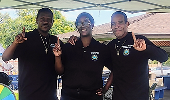 Two White Fund Board members and a community member tabling a Juneteenth 2025