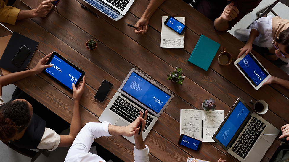 multiple people working on laptops and tablets.png