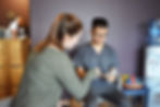 Massage therapist holding clipboard with patient