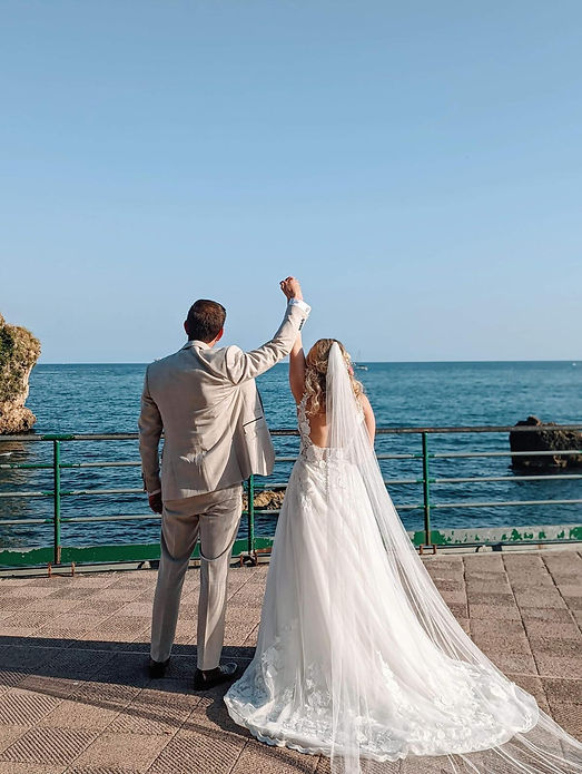 bride and groom fist pumping the air holding hands
