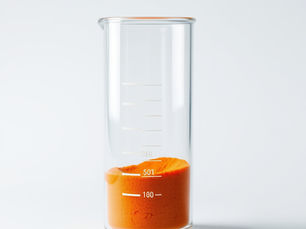 Lab beaker with orange powder