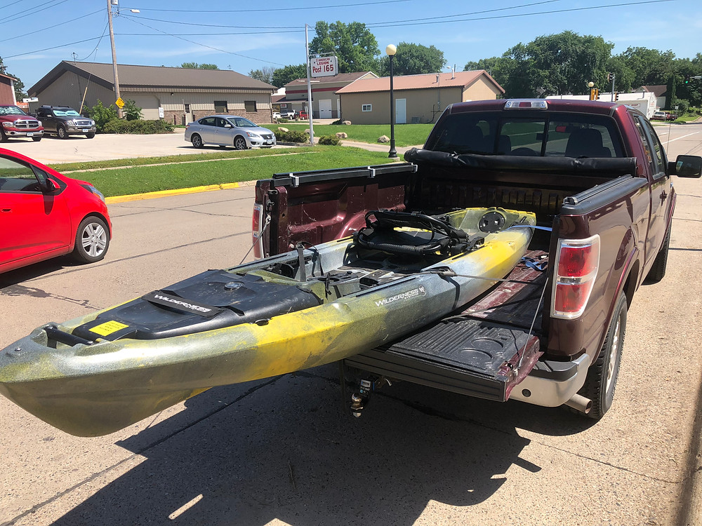 Yellow/black Kayak in truck bed
