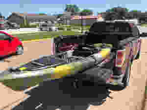 Yellow/black Kayak in truck bed