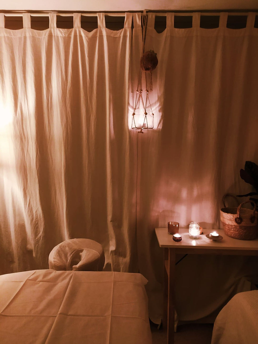 Cozy massage room with candles and vertical curtains