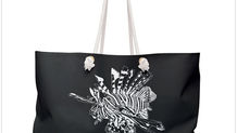 A black canvas tote bag with a large white lionfish illustration on both sides.