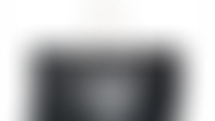 A black canvas tote bag with a large white lionfish illustration on both sides.