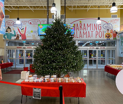 14 foot Christmas tree at the front of a grocery store decorated with white lights