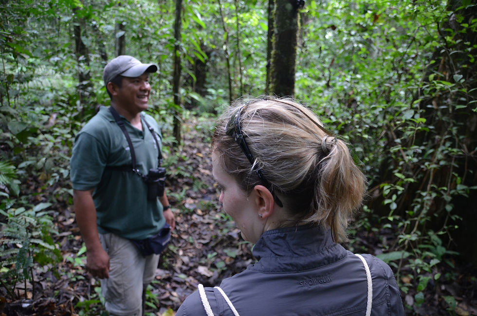 tour guide laughing and author's back to the camera with a green lizard on hair