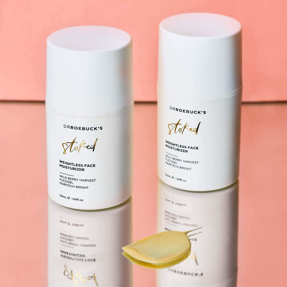 two bottles of Dr Roebuck's Weightless Face Moisturizer and yellow cream smeared in front