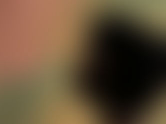 A Black woman standing and pausing in quiet reflection and calm.