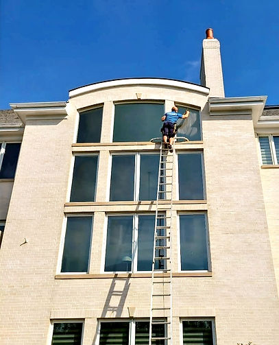 Man washing exterior windows
