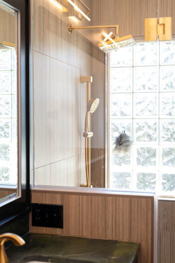 Glass-enclosed shower with wood tile and glass block window
