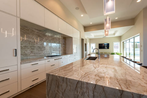 Kitchen island with waterfall stone countertop and contemporary finishes in Wichita KS.