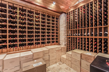 Custom wine cellar with floor-to-ceiling wood wine storage and built-in racking in Wichita KS.