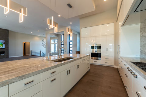 Bright open kitchen with white cabinetry and streamlined layout