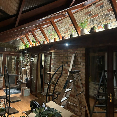**Alt text:**
Bright conservatory lighting installation with modern ceiling spotlights, creating a welcoming and functional living space for year-round use.