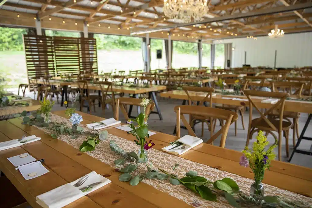 long oak tables set for a wedding 