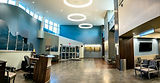 The main lobby at Clay County Medical Center features a spacious, welcoming entrance with natural light, comfortable seating, and modern design elements that create a warm environment for patients and visitors.