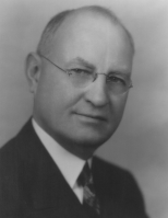 black and white portrait of Dane G. Hansen in a suite and tie