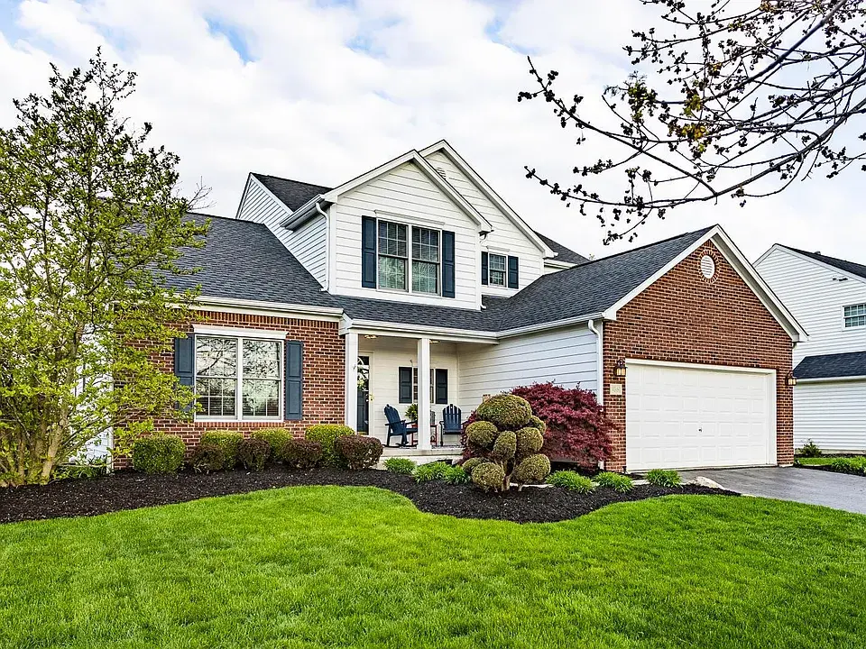Eye-level view of a modern suburban neighborhood with new homes and green lawns