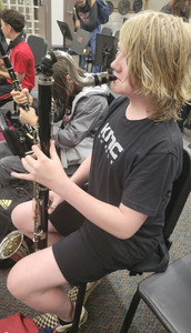 A student playing a bass clarinet.