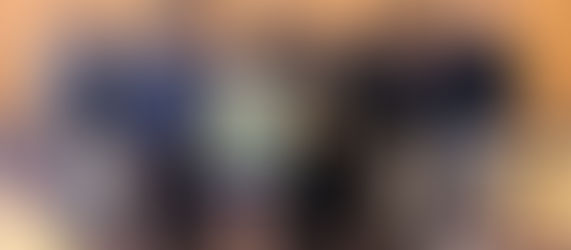 Group of smiling teens with medals; one holds a chessboard, another a trophy.