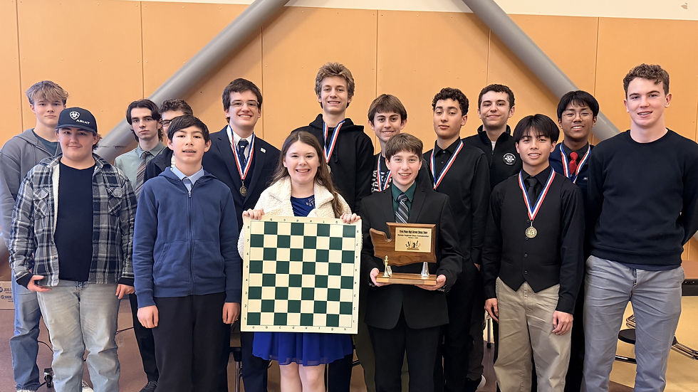 Group of smiling teens with medals; one holds a chessboard, another a trophy.
