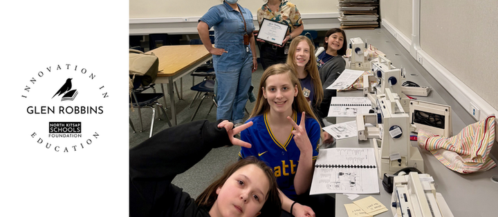 Circular Glen Robbins Innovation in Education Logo is to the left of an image. The image shows a group of girls pose and smile in a classroom with sewing machines. Lynn Atherton and Natasha Shodd stand smiling, Atherton holding a Glen Robbins certificate.
